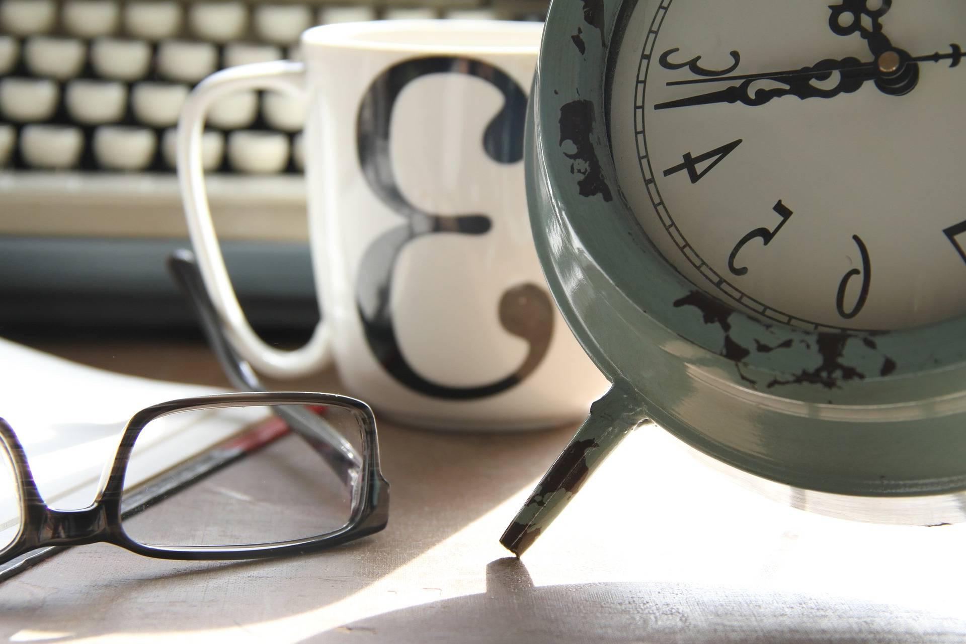 coffee cup with glasses and clock